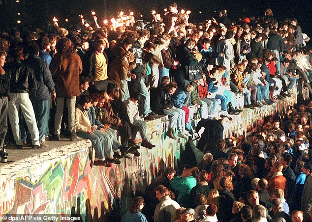 Technology has been a factor in this turning point, too, as the Russians seem to be waging a 20th Century war against a 21st Century defence. Pictured: This photo taken on November 11, 1989 in Berlin shows young East Berliners celebrating atop the Berlin Wall