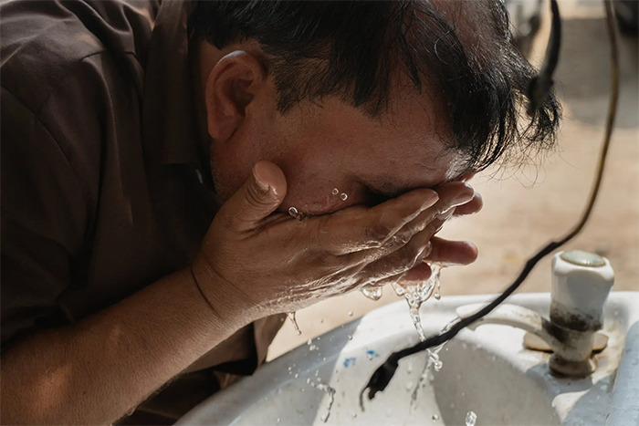 man washing his face