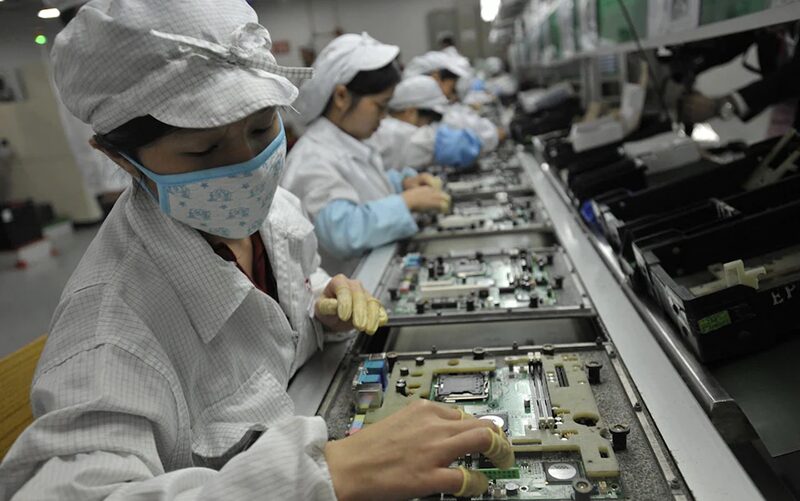 Workers at one of Foxconn’s controversial factories in southern China Credit: AFP