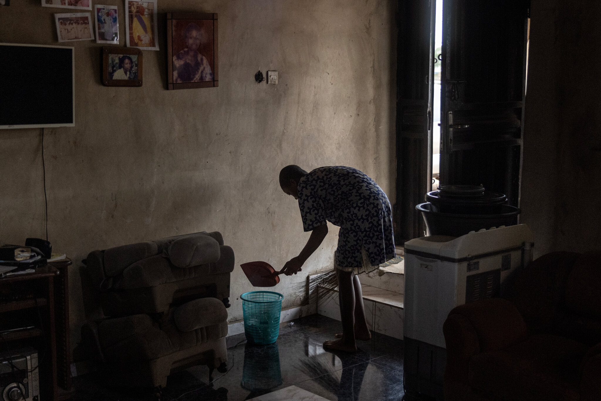 Deborah Olasupo, 16, at home. “When we mop,” her mother said, “our feet are black.” Finbarr O'Reilly for The New York Times