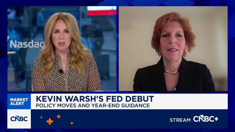 CNBC split-screen interview: anchor on left, guest on right; lower banner reads 'KEVIN WARSH'S FED DEBUT' and 'POLICY MOVES AND YEAR-END GUIDANCE'