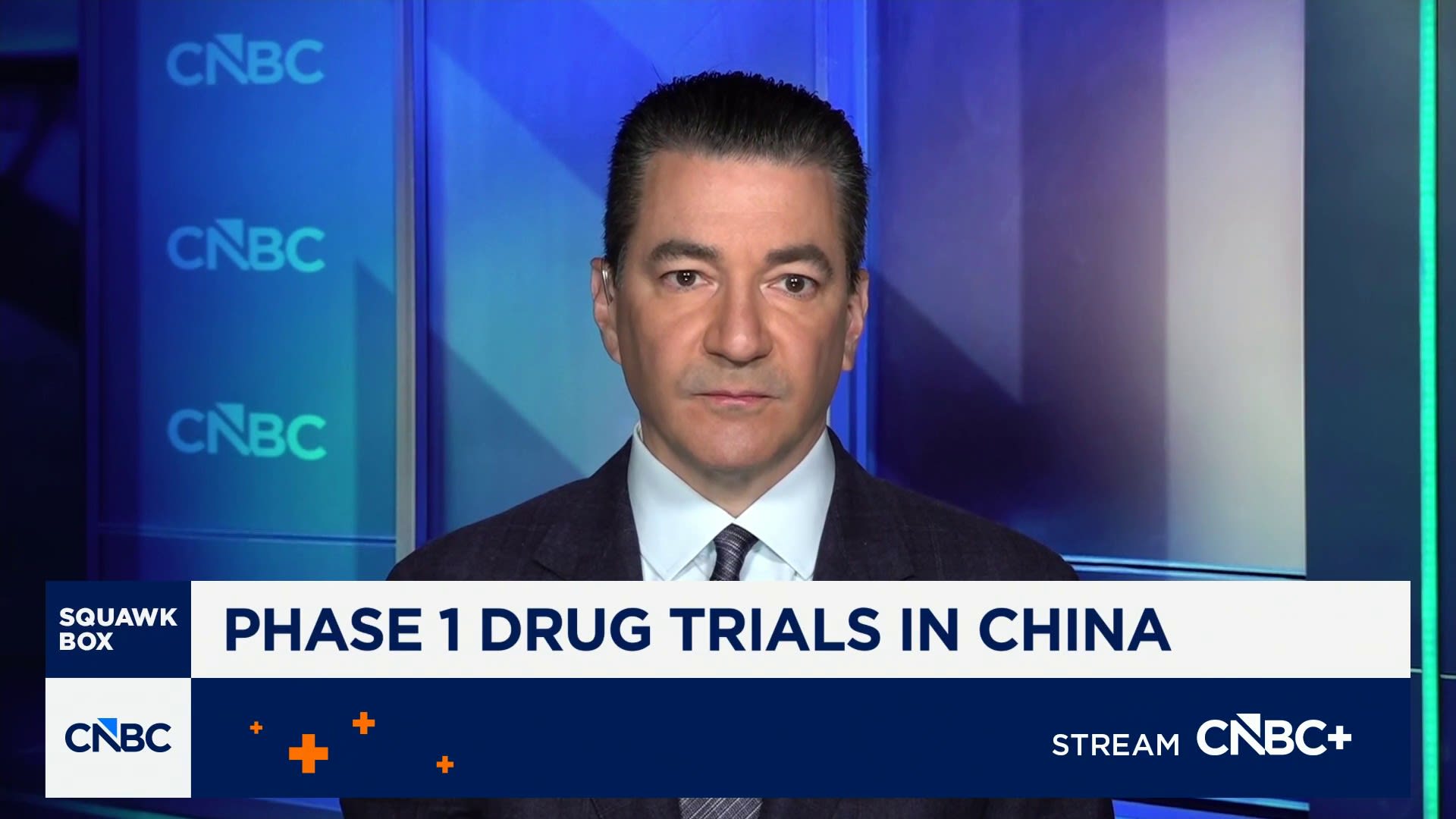 CNBC news anchor in a suit on air, lower third reads 'PHASE 1 DRUG TRIALS IN CHINA' with CNBC logo and 'Squawk Box' label.