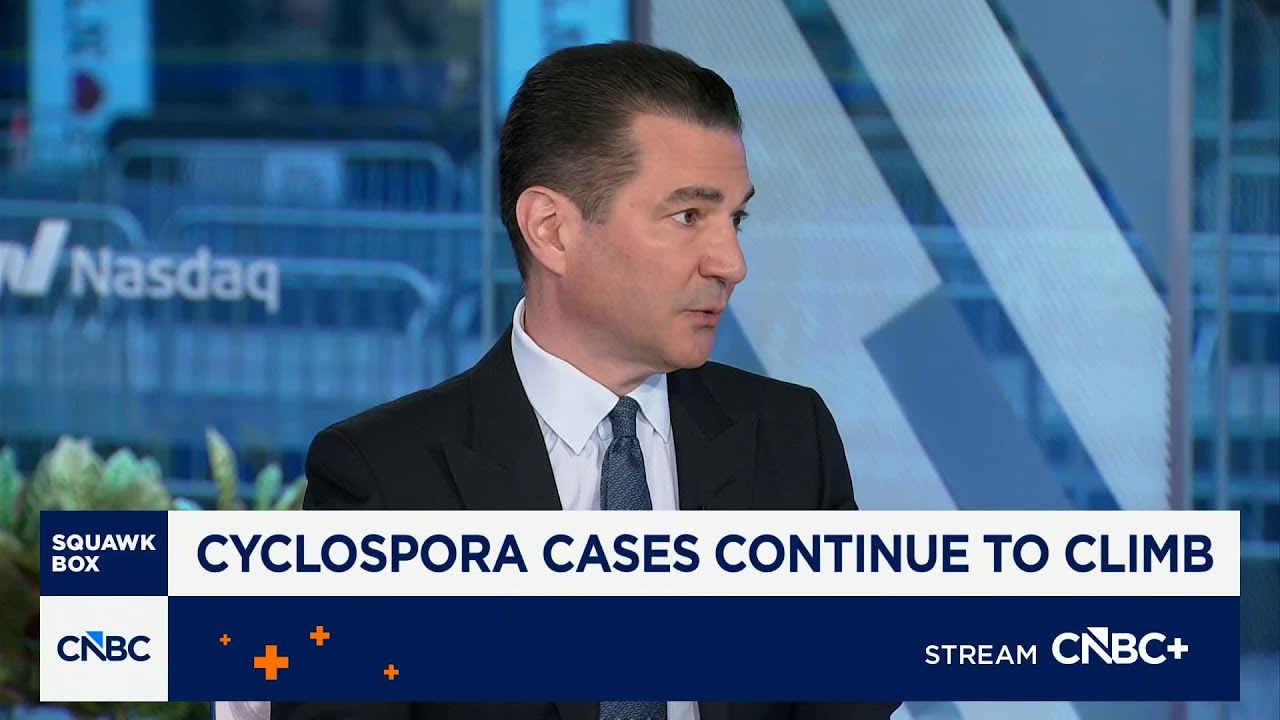 Man in a dark suit being interviewed in a CNBC studio, banner reads 'CYCLOSPORA CASES CONTINUE TO CLIMB' with CNBC+ graphic at bottom.
